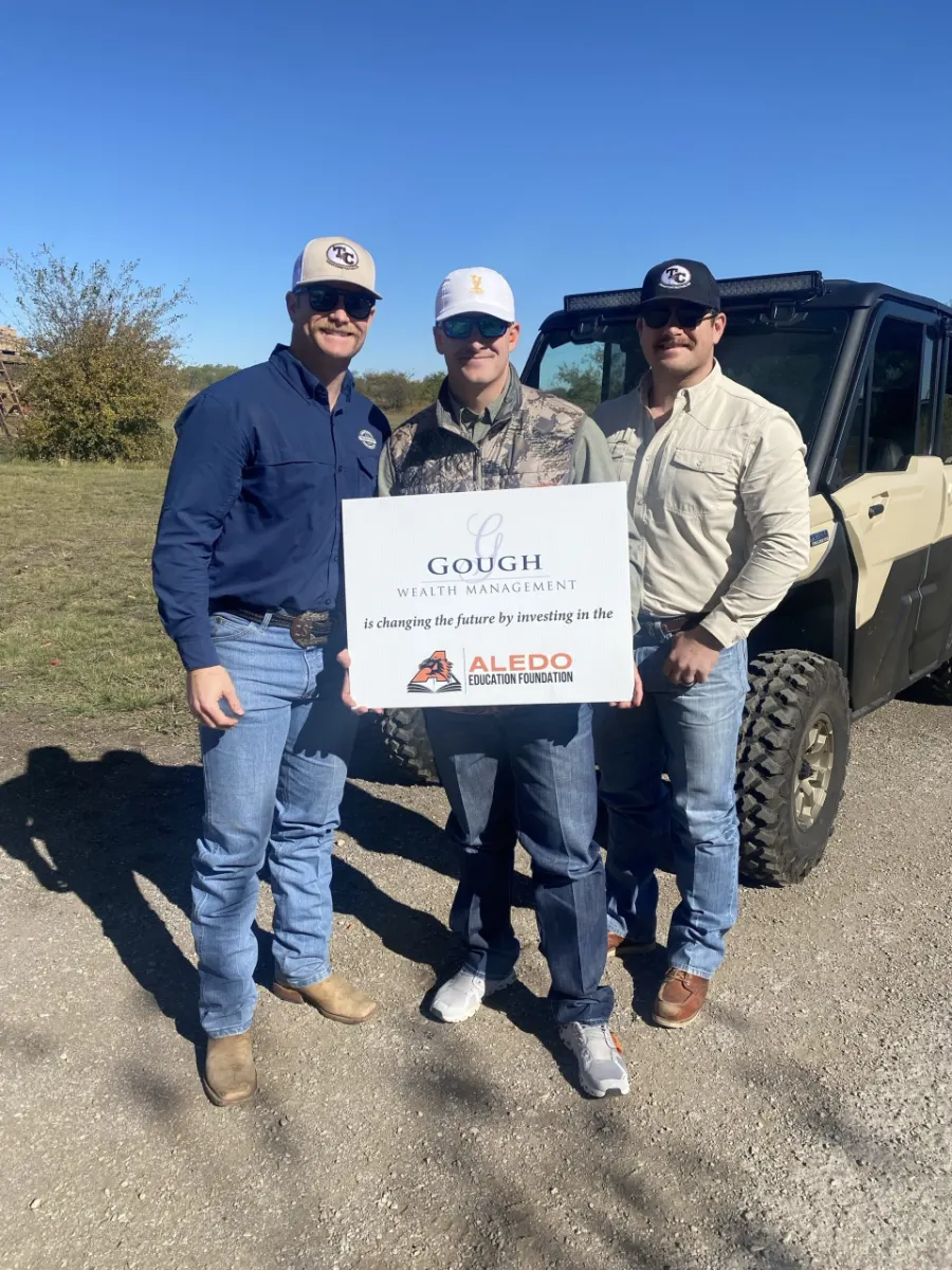 Part of the Gough Wealth Management team poses with one of the Aledo community groups they invest in