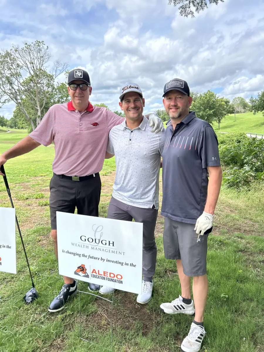 Brent & Slaten Gough of Gough Wealth Management pose with a sponsorship sign at a golf tournament