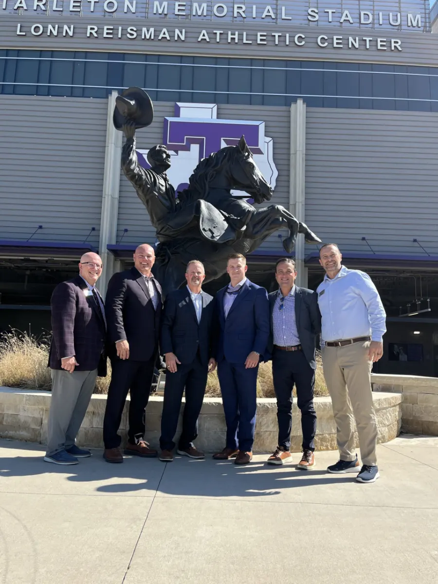 Members of the Tarleton State University financial planning advisory council, where Brent Gough serves, outside a campus stadium